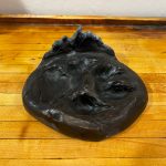 bronze wolf track art piece
