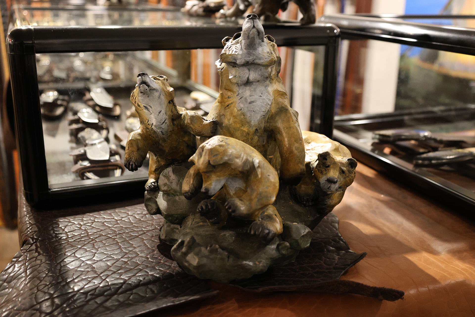 bronze statue of a mama bear and her three cubs